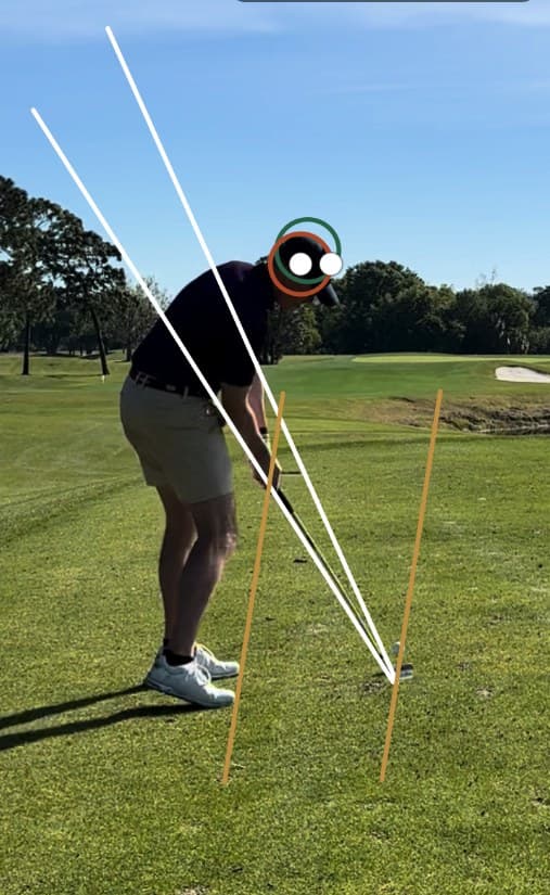 Downswing position with swing-plane and alignment lines drawn by a coach